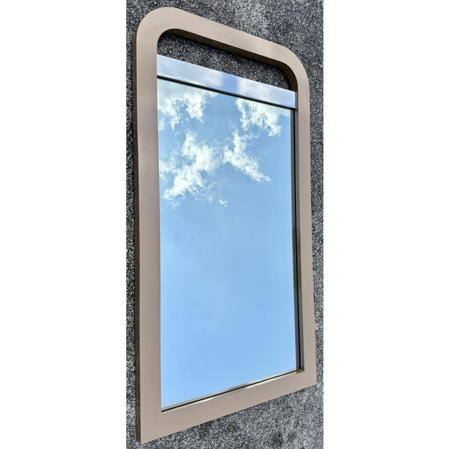 Cool, waterfall shape, wall mirror from 70's. Made of mica in a taupe color. Horizontal chrome accent bar on top.