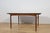 This is a rectangular-shaped teak dining table manufactured by G-Plan in the 1960s. The table has reinforced edges of the...