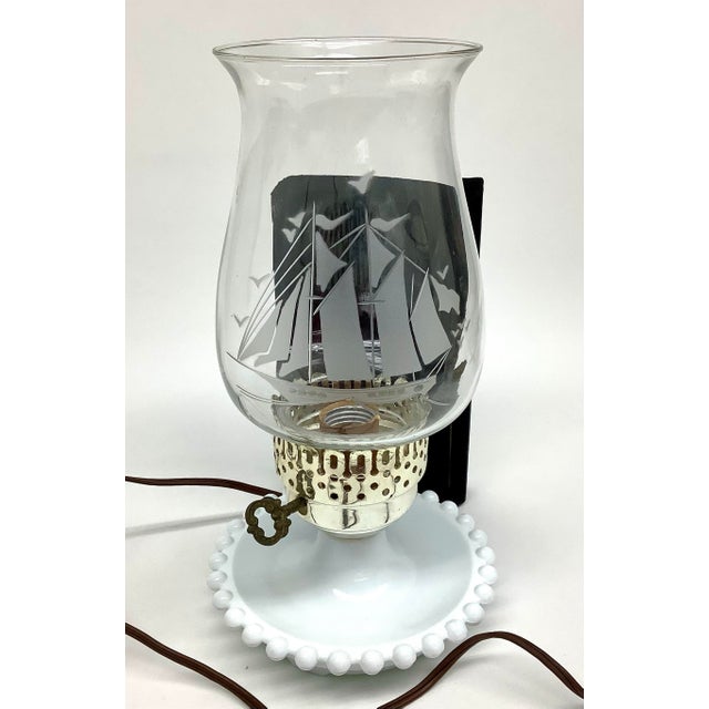 Vintage lamp with hobnail base and clear hurricane sailing ship chimney shade. Each little nub has a dot of gold paint on...