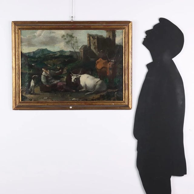 Oil on canvas. In a Nordic-type landscape, with mountain chains in the background and green hills, a small herd of cows is...