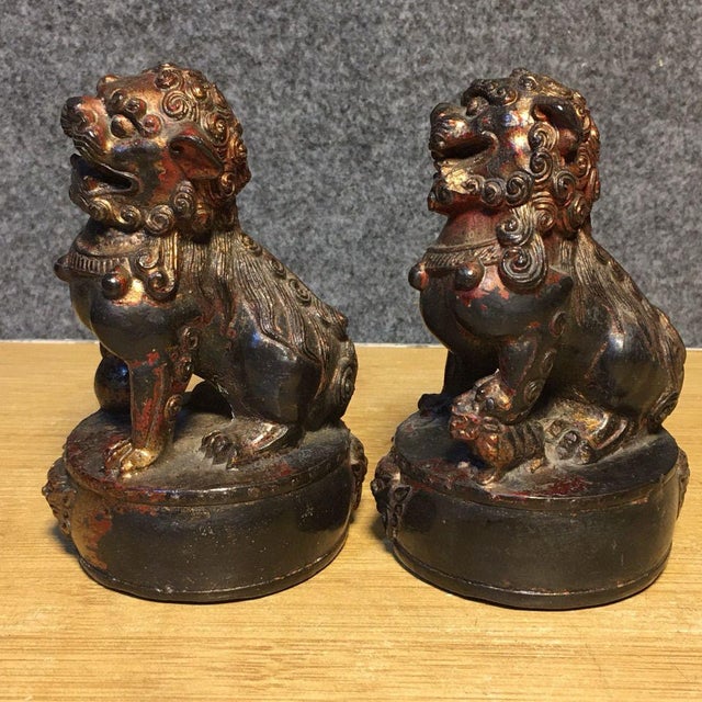 This is a charming pair of vintage Chinese bronze guardian lions, also known as Foo Dogs or Shishi. Each lion is seated on...