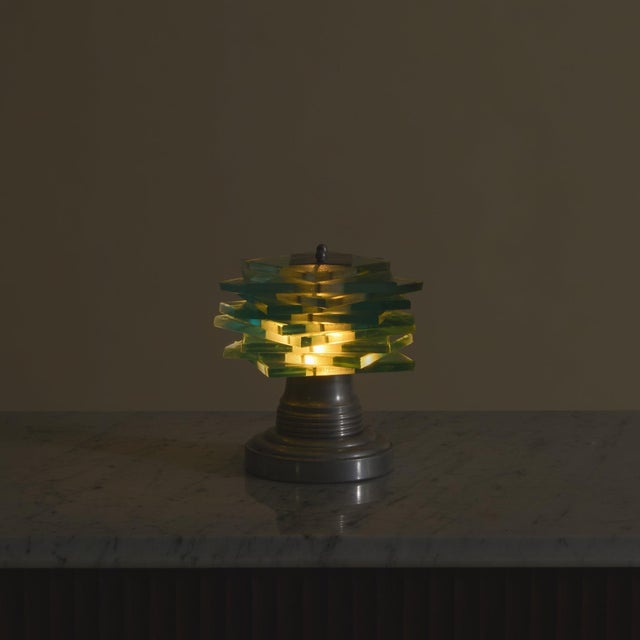 A petite French Art Deco table lamp by Maison Desny, dating to the 1930s. The nickel-plated brass base is profiled with...