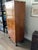 Exemplifying the understated elegance and functional sophistication of the period, this antique Biedermeier tall chest of...