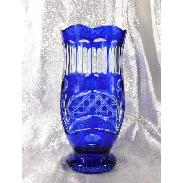 This is a blue cut to clear vase. I have two of them, but they are not exactly the same. This one has a shallow scalloped...