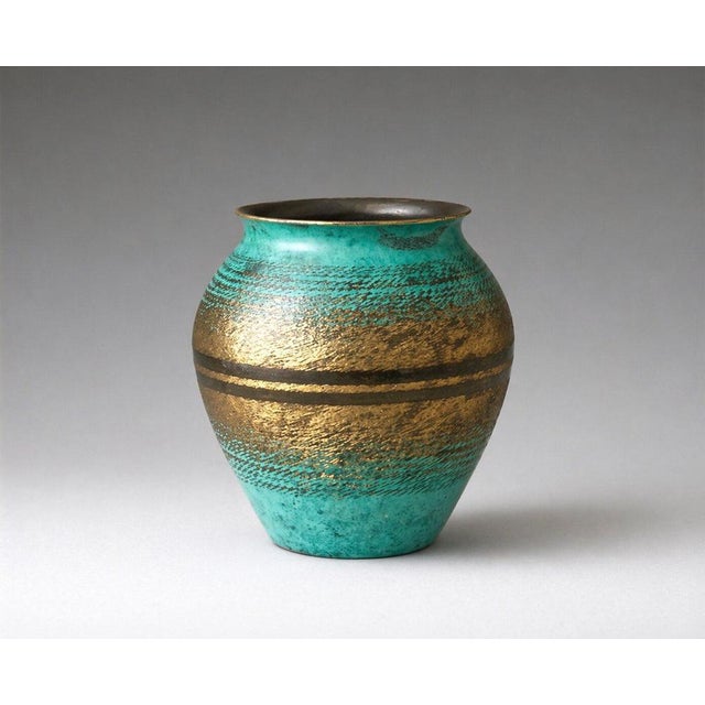 A rare and finely executed wmf ikora vase from the 1930s, produced in patinated bronze and showcasing the distinctive...