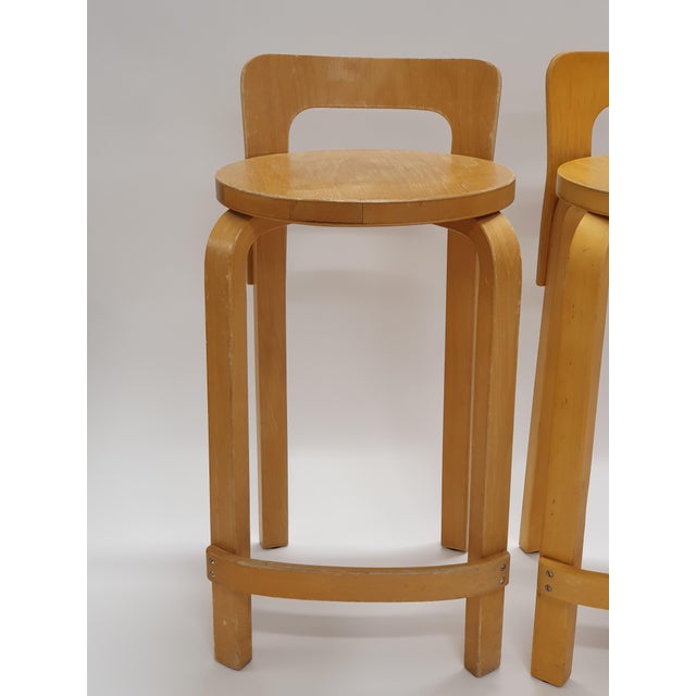 Artek K65 stools 4 pcs, design by Alvar Aalto. In good used condition and great patina of age. This piece has an...