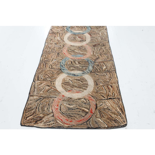 This striking pair of vintage American hooked rugs showcases a bold and visually engaging overlapping rings motif that...