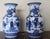 Elegant pair of blue and white Chinese porcelain vases featuring richly detailed figural and landscape scenes with...