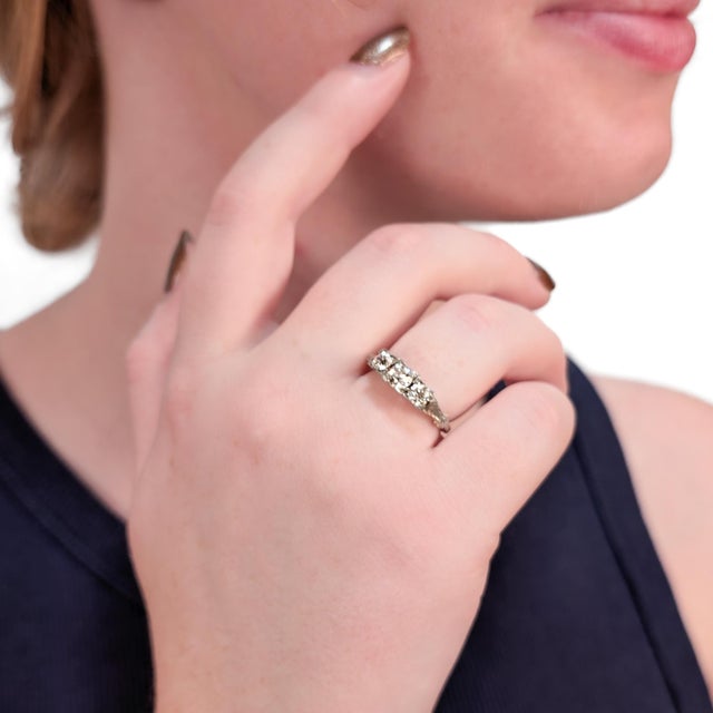 A fine antique 3-stone diamond ring. In 18 karat white gold. With a central bezel-set Old European cut 0.38± Ct diamond...