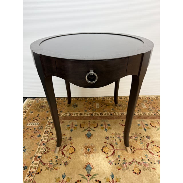 Design Plus Gallery presents the Barry Side Table from Madeline Stuart. This dark wood mahogany table has antique nickel...