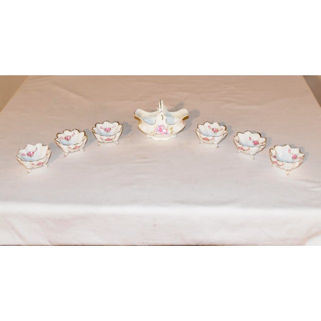 This is a lovely set of a porcelain basket and six small bowls made in Germany and with transferred floral decoration. The...