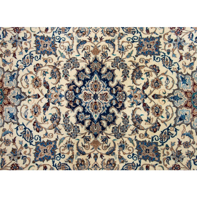 A wonderful late 20th century Persian Kashan rug with an elaborate all-over pattern woven with myriad large and small...