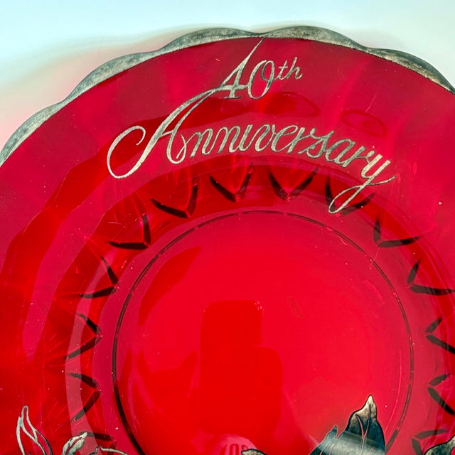 A beautifully substantial piece of mid-century commemorative glass, this ruby red anniversary plate is adorned with an...