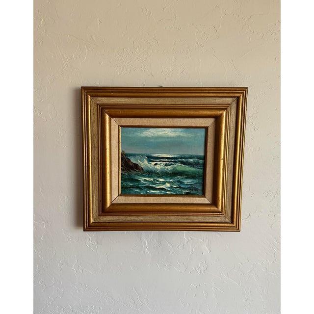 This vintage 1960s oil painting of a seascape by David Crespi depicts crashing waves against a rocky outcropping. The...