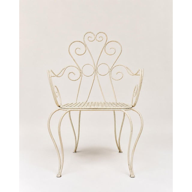 Set of 3 white wrought iron chairs. Elegant and charming with their graceful curves, they will add a romantic touch to...