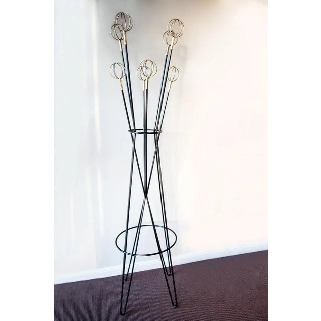 Elegant Wardobe / Coat Stand, "Astro", France circa 1950, brass, black lacquered metal Condition: very good, original...