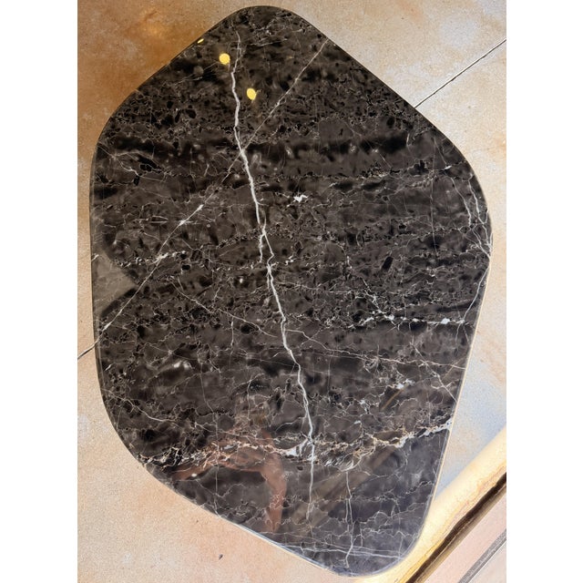 Bring a sophisticated designer touch to your living space with this contemporary coffee table, featuring a stunning black...