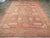 The light brown field of this early 20th century Turkish carpet displays a central octagon with smaller up design...