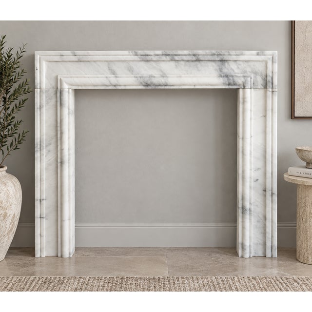 Elevate your interior with this handcrafted Ziarat White Marble Fireplace Surround, made from natural Ziarat White Stone...