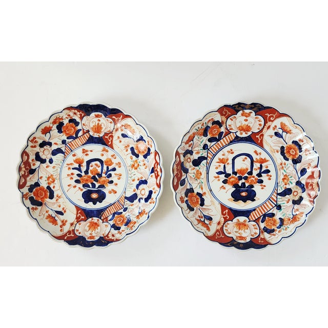A beautiful pair of antique 19th Century Meiji Period Imari scalloped plates with handpainted floral design, in the...