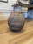 Substantial antique earthenware vessel featuring a beautifully weathered surface with natural mineral deposits, aged...