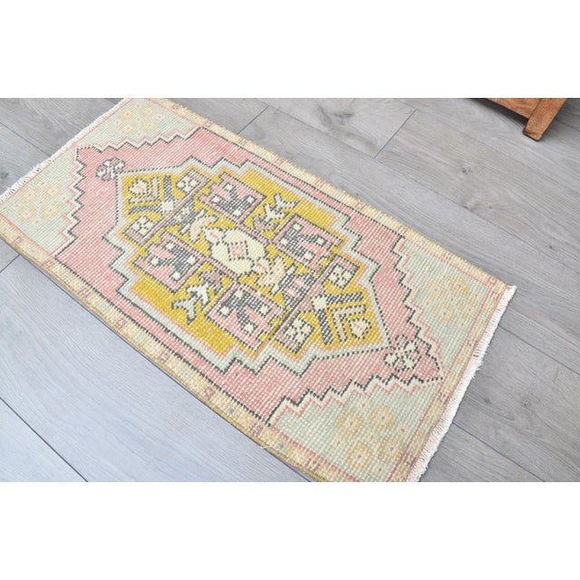 This is a vintage Turkish Oushak rug from the 1960s. The piece was hand-knotted.