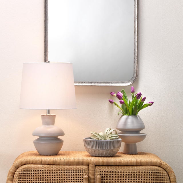 This bold vase offers an eye-catching accent to any tabletop. Handcrafted of ceramic in a matte textured finish, it...