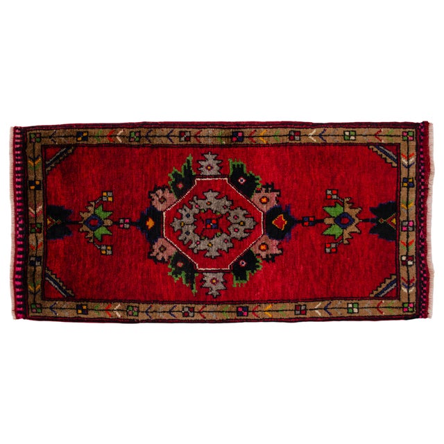 Welcome this exquisite piece of Anatolian heritage into your curated space. This vibrant, hand-knotted petite mat is...