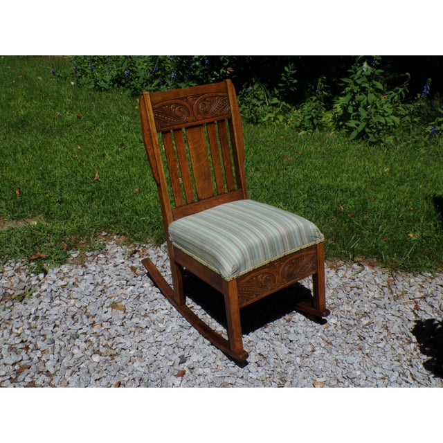 Antique Arts & Crafts rocking chair from the early 20th century is constructed of Oak, known for it's stability and...