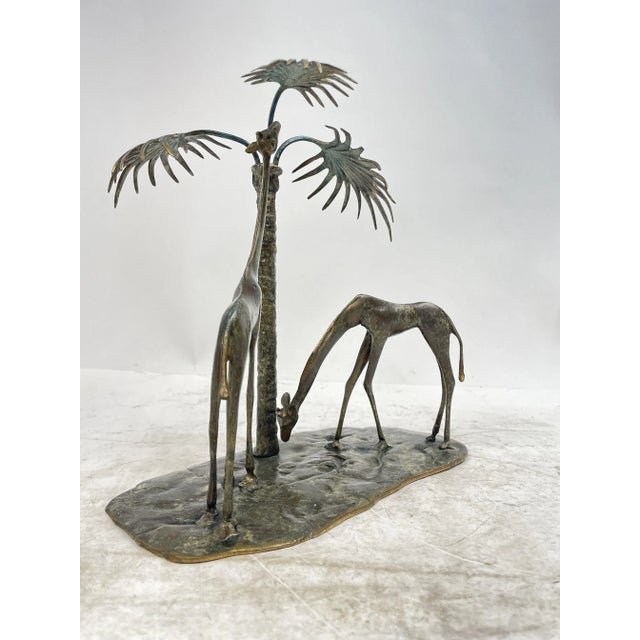 Beautiful bronze sculpture depicting giraffes with palm trees. Excellent ornament.