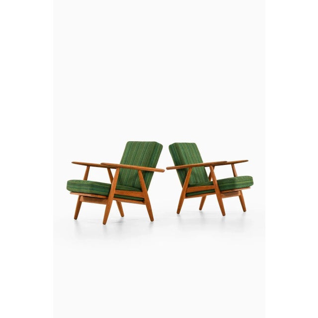 Easy chairs in oak with original fabric by hans wegner, 1950's additional information: material: oak and original fabric...