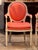 Pair of vintage painted French armchairs with oval backs in molded cream painted frames. The padded arms end in scrolled...