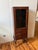 A classic, upright medical-style cabinet designed for utility and display. Features a single glass door for showcasing...