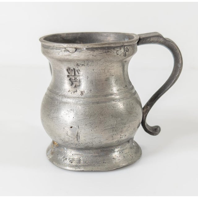 We are selling this cute and charming English pewter miniature two handled tankard. The mug has two hallmarks one with...