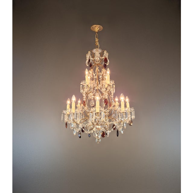 This decorative chandelier is in the Venetian style. Its curved lines, open, multi-tiered structure, and diverse crystal...