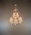 This decorative chandelier is in the Venetian style. Its curved lines, open, multi-tiered structure, and diverse crystal...