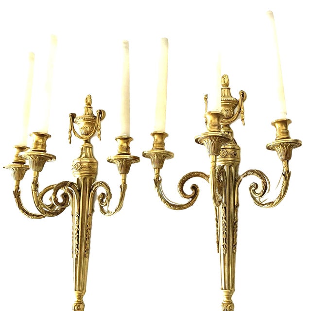 Elegant pair of large french louis xvi-style wall sconces in finely cast gilt bronze,featuring three gracefully scrolling...