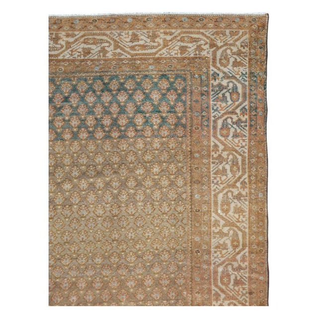 This mid-20th-century Persian Malayer carpet presents a finely patterned allover composition in warm camel, taupe, beige,...