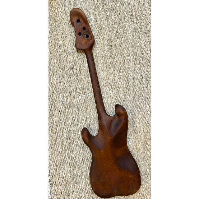 1970s Solid teak hand carved sculpture of a Japanese bass guitar. All of the nuances are here. Beautifully carved from one...