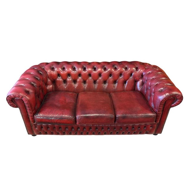Genuine three seat sofa with deep button tufting. Traditional Chesterfield with rolled arms and studded detailing Thick,...