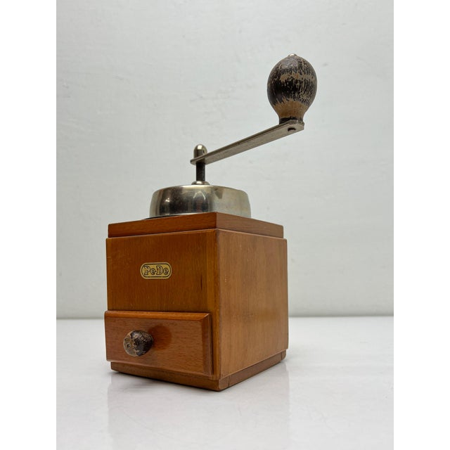 Authentic coffee grinder from the Netherlands, 1950s. Solid wood cabinet with drawer and brass PeDe emblem. The top is...