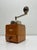Authentic coffee grinder from the Netherlands, 1950s. Solid wood cabinet with drawer and brass PeDe emblem. The top is...