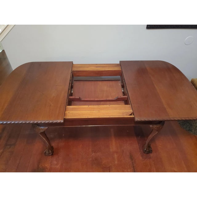 A classic mid-century, Chippendale Revival dining table, crafted in the United States circa 1952-1957. This piece...