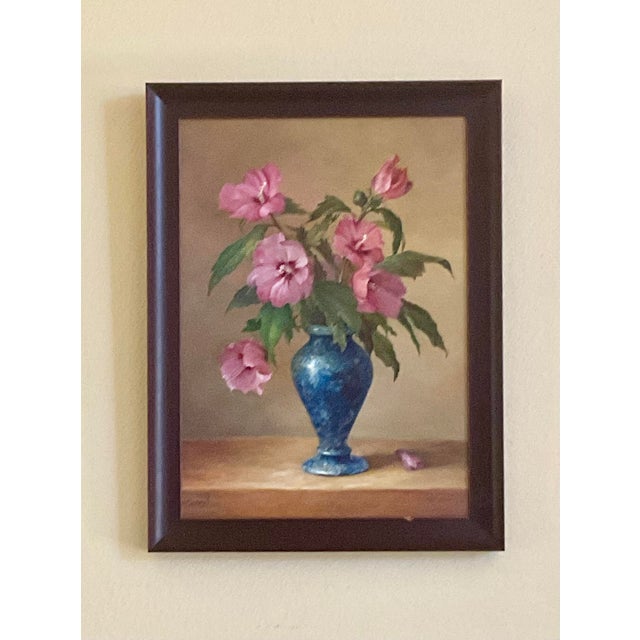 A richly composed late 20th‑century still life, this oil on board features a classical arrangement of flowers gathered in...