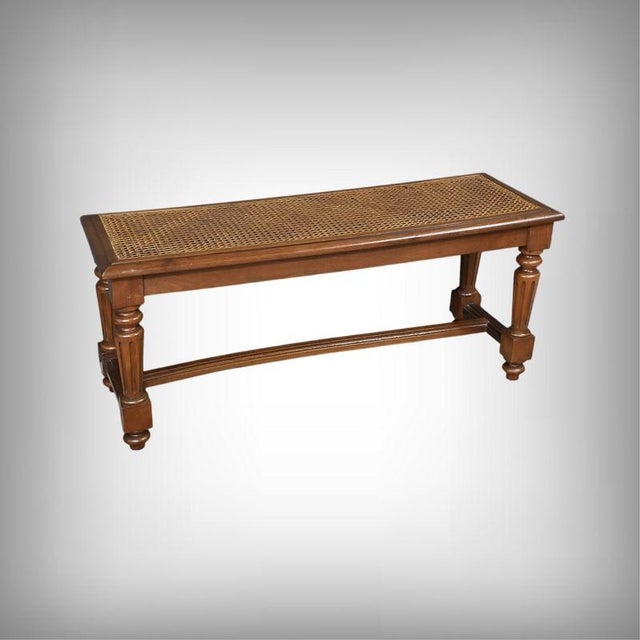 This Louis XVI-style piano bench in walnut with beech legs features a rectangular seat. The seat is made of canework...