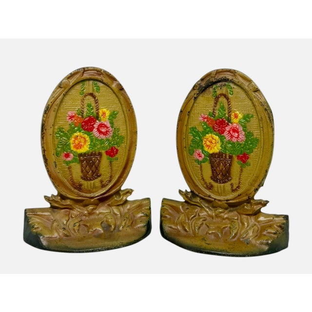 1920’s Cast Iron Bookends Handpainted Enamel Finish Oval Shape Basket Filled With Flowers Motif - A Pair. These cast iron...