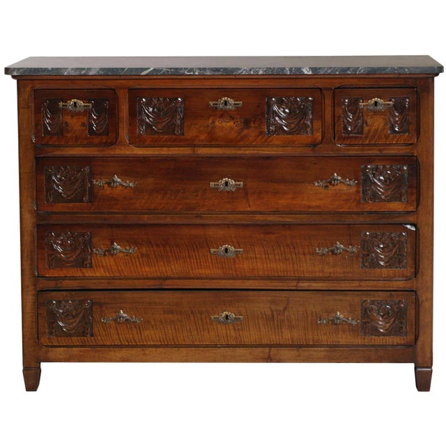 This chest of drawers is made of solid walnut and richly hand carved.