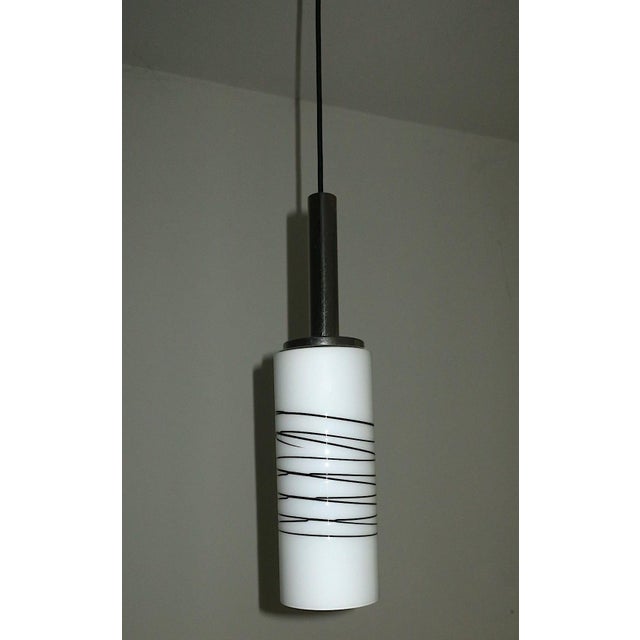 White opaline glass pendant light, cylindrical shape with a fine black glass overlay decoration, chromed metal holder,...