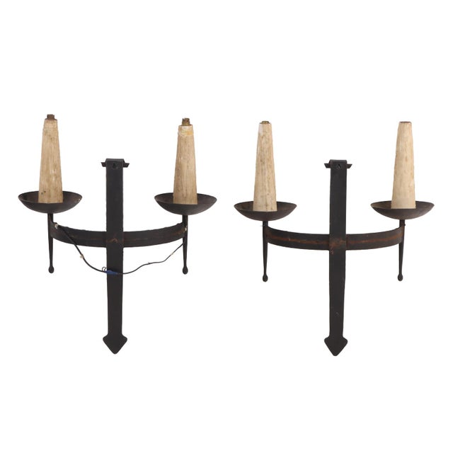 A striking set of four sconces. Each sconce features a pair of scrolling arms, each supporting a single electrified...