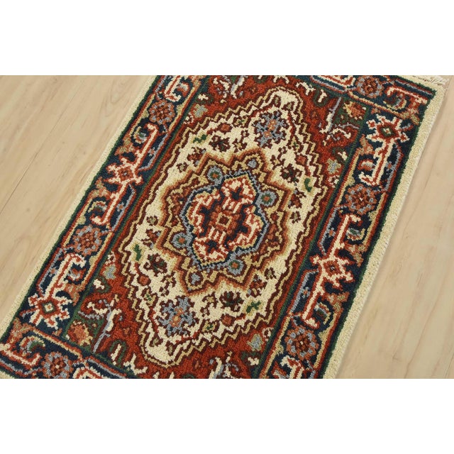 A traditional tribal Heriz rug hand-knotted with fine wool on a cotton foundation. This oriental rug features a central...